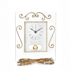 Pendulum clock in glass and gold metal